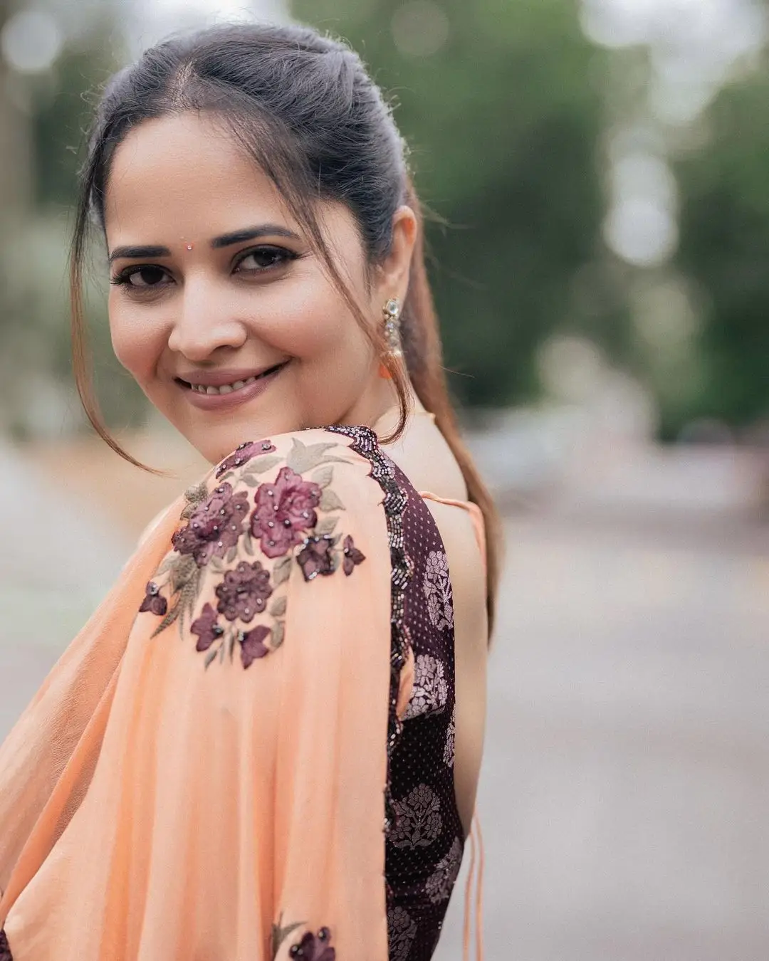 Anasuya Bharadwaj Wearing Beautiful Earrings Orange Saree Blouse